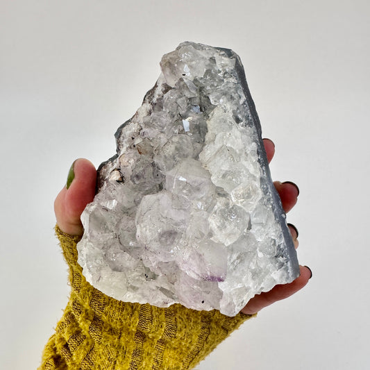 Self-standing amethyst geode crystal cluster from FoxlarkCrystals with purple crystal formations on a neutral background