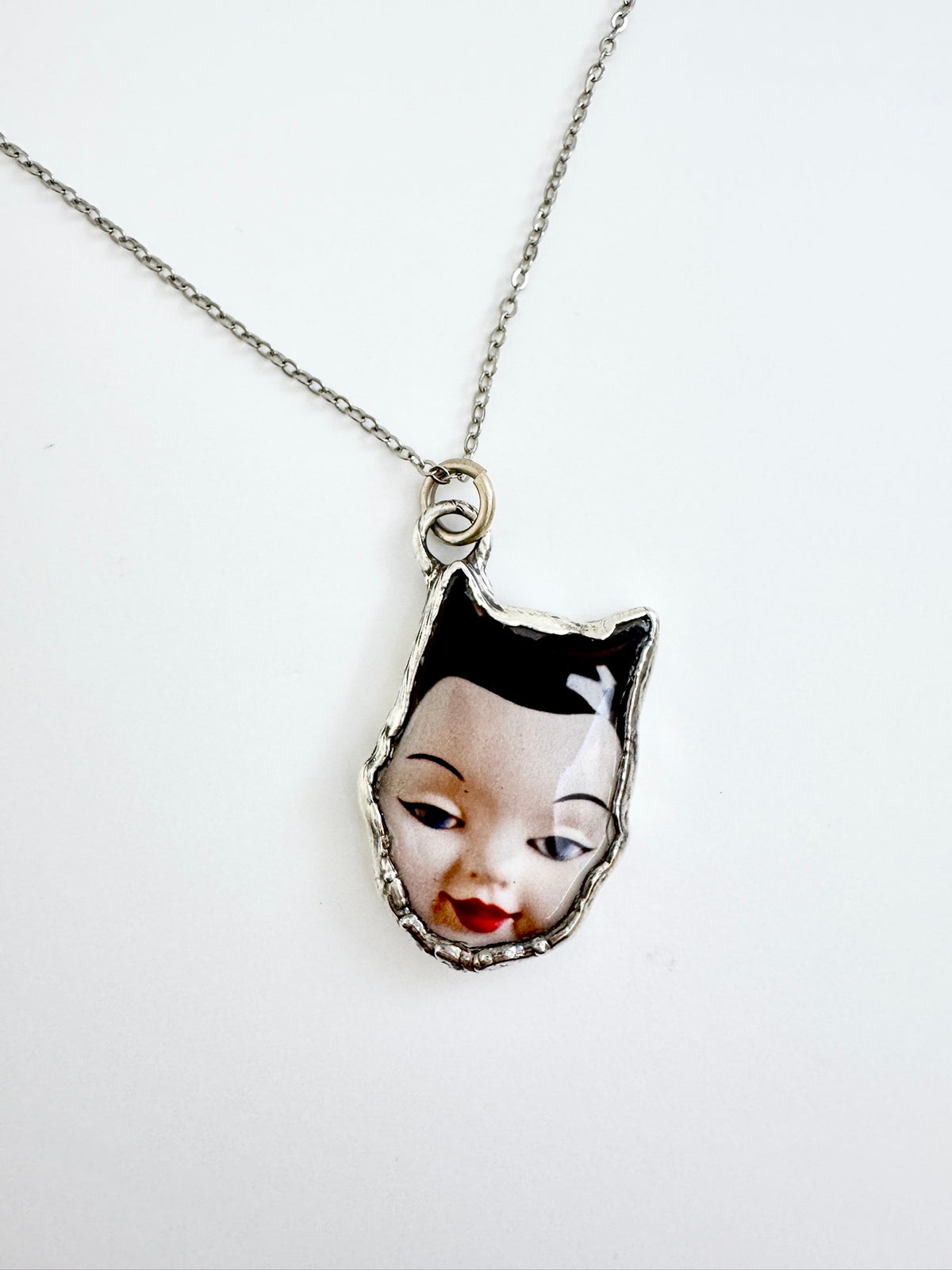 side eye doll head necklace, fine silver
