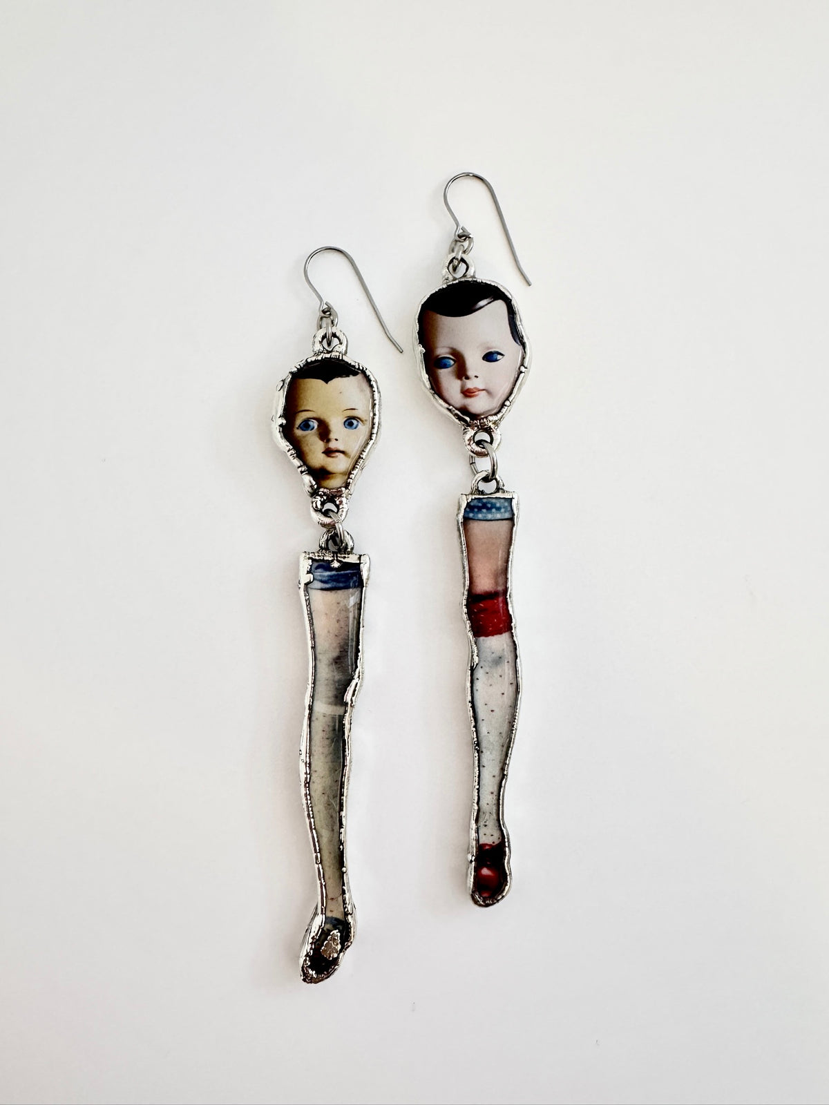 mismatched doll head and leg dangle earrings, silver