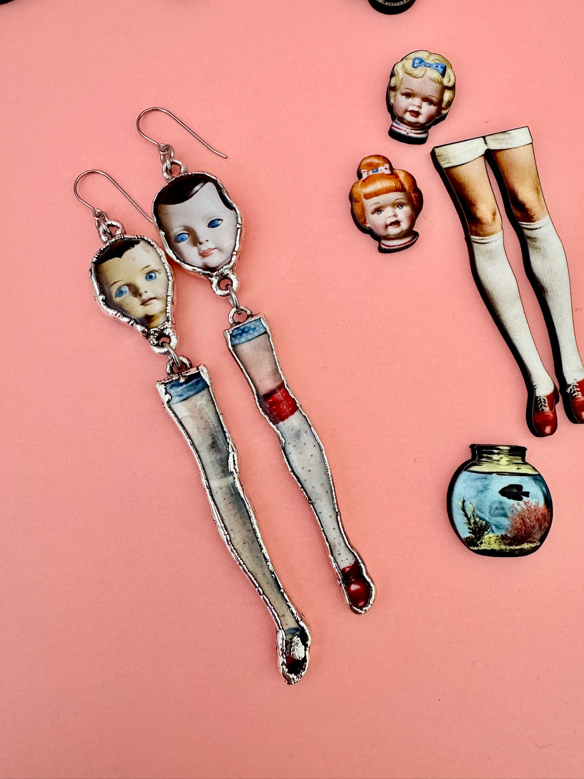 mismatched doll head and leg dangle earrings, silver