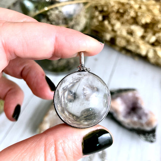 FOXLARK silver crystal ball necklace featuring a large clear quartz pendant with a sleek silver chain.